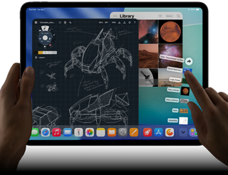  iPad Pro, vesmírně černá barva, levá ruka drží zařízení, pravá ruka ukazuje a gesty ovládá okna různých otevřených aplikací, aplikace na kreslení s náčrtky mechanických strojů, knihovna fotek se snímky planet a vesmíru, rozložené zobrazení souborů ve složce stahování