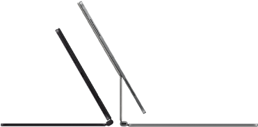 Dva iPady Pro připnuté k Magic Keyboardu, pohled z boku, tenký profil, vesmírně černá barva, reproduktory a USB‑C port, jeden napůl otevřený, druhý ve stříbrné barvě otevřený a nakloněný dozadu, takže je vidět plovoucí konzolová konstrukce klávesnice, reproduktory a mikrofon